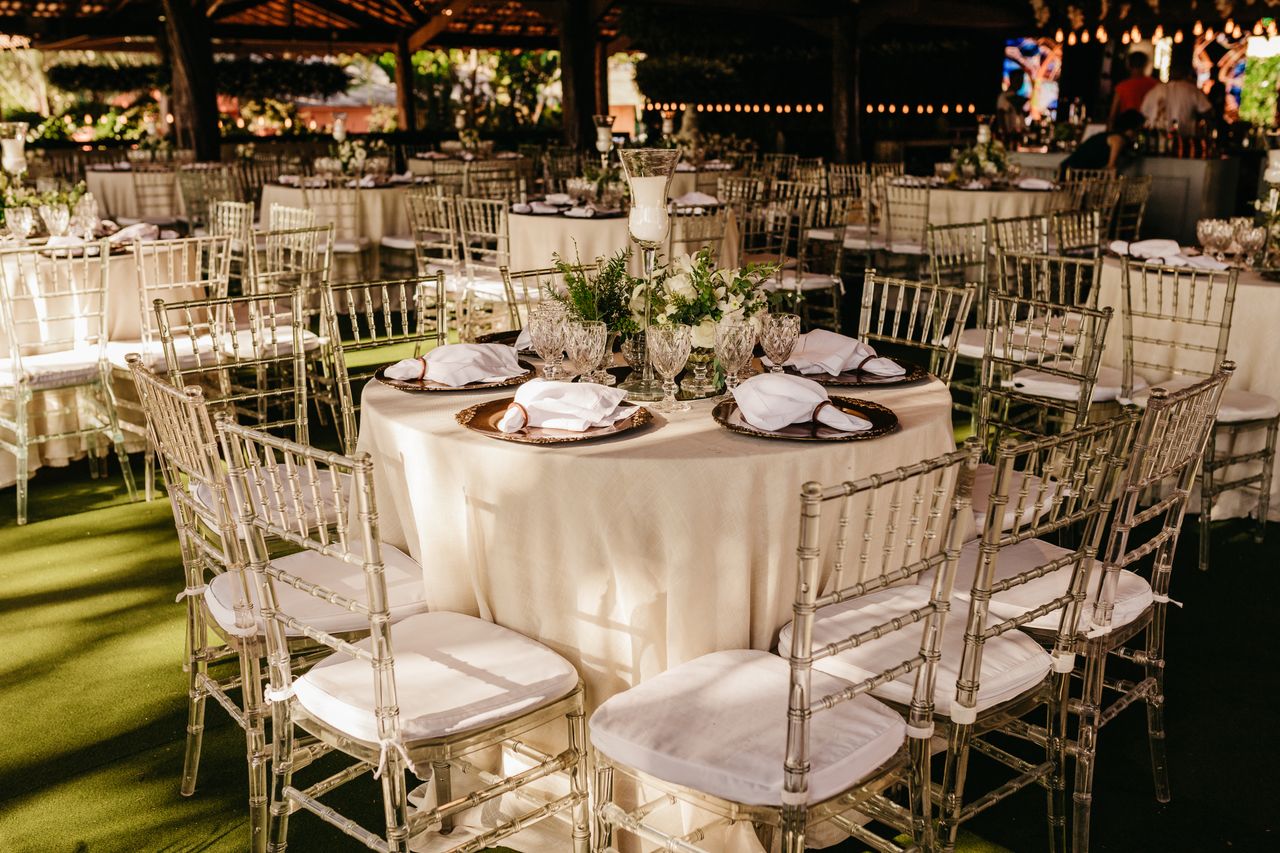 Home Chic outdoor wedding reception with elegant table setup and floral arrangements.