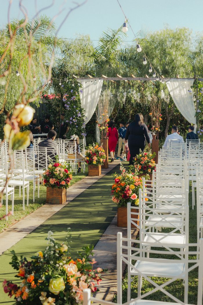 Beautiful outdoor wedding setup with chairs and floral arrangements. Perfect garden ambiance for celebrations.